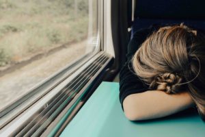 Woman head down on a train
