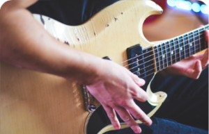 Close up of a person playing an electric guitar