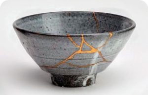 A grey bowel with gold veins where areas have been repaired