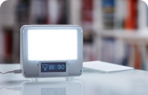A lamp screen on a table, with a battery percentage of 90 below it