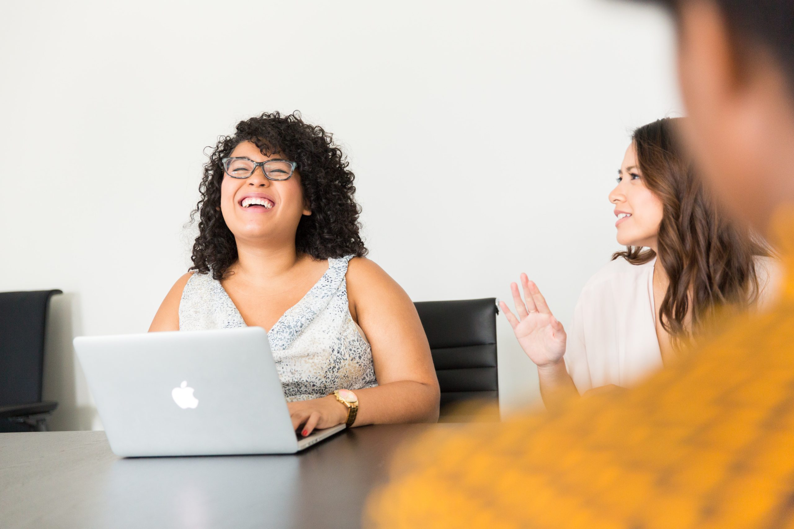 people laughing at desk